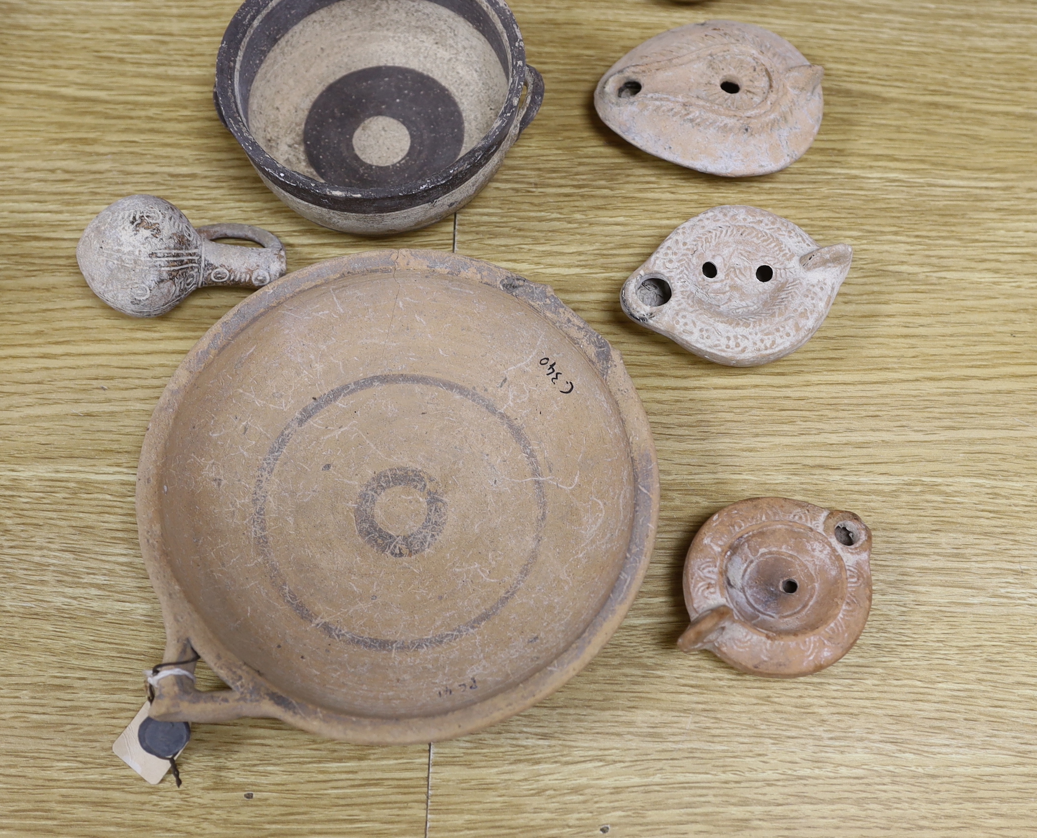 Assorted Cypriot pottery ‘antiquities’, to include bichrome pottery vessels, Cypro-Archaic, c.750-600 BC, Roman terracotta oil lamps, a Byzantine sgraffito ‘phoenix’ bowl, 13th/14th century, 16cm. Provenance - collected